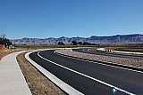 Wide sidewalks on both sides of the gently curved street - Street Art of Grand Junction